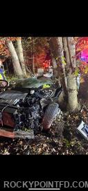 Vehicle pinned between trees which needed to be cut to make access to vehicle.