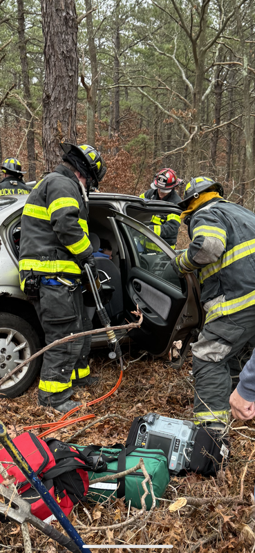 Members from R-4 and TL-14 use the Jaws of Life to disentangle and extricate a victim of an auto collision. 